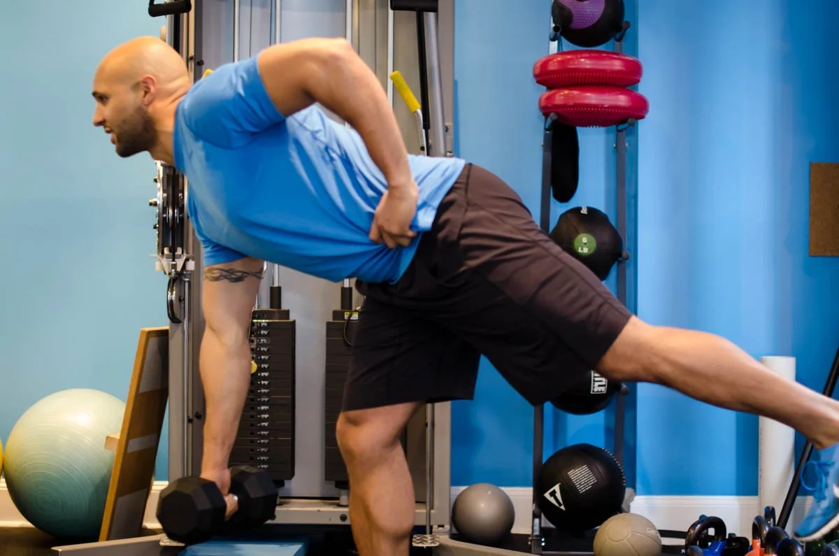 Earl demonstrating a single-leg dumbbell row