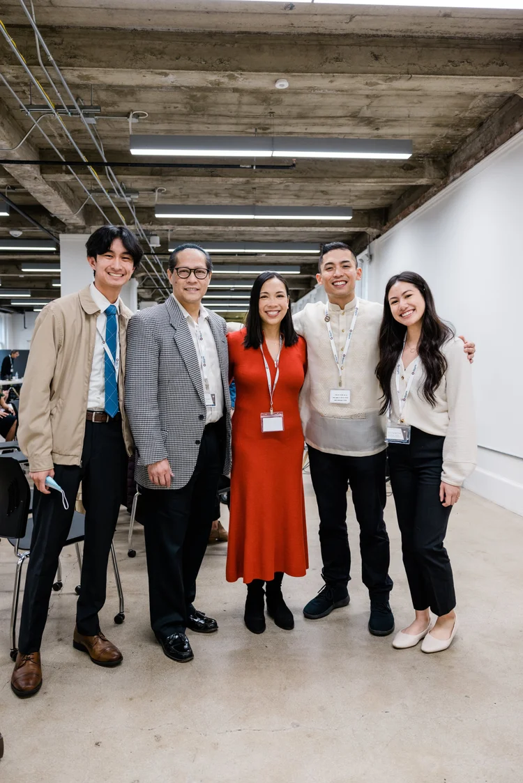 Five conference attendees, students and physicians, smiling together