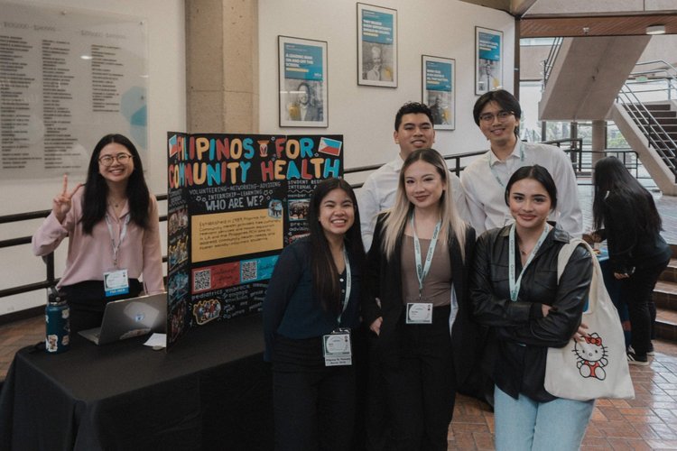 Students and trainees at a Filipinos for Community Health poster booth