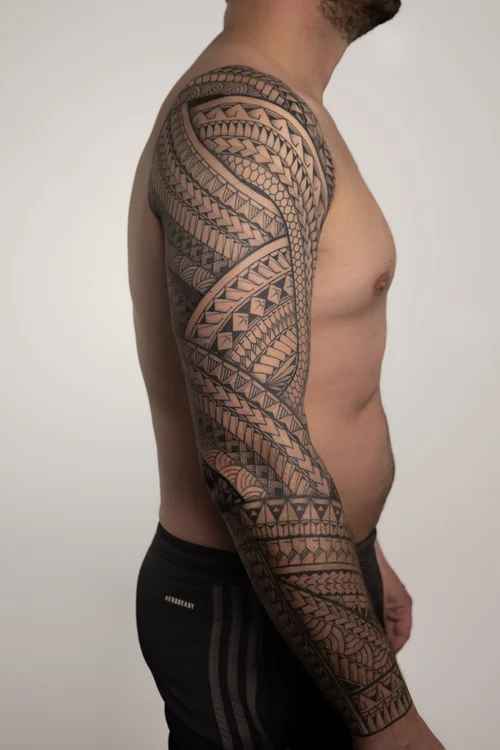 Polynesian arm tattoo by Mateusz Krygowski