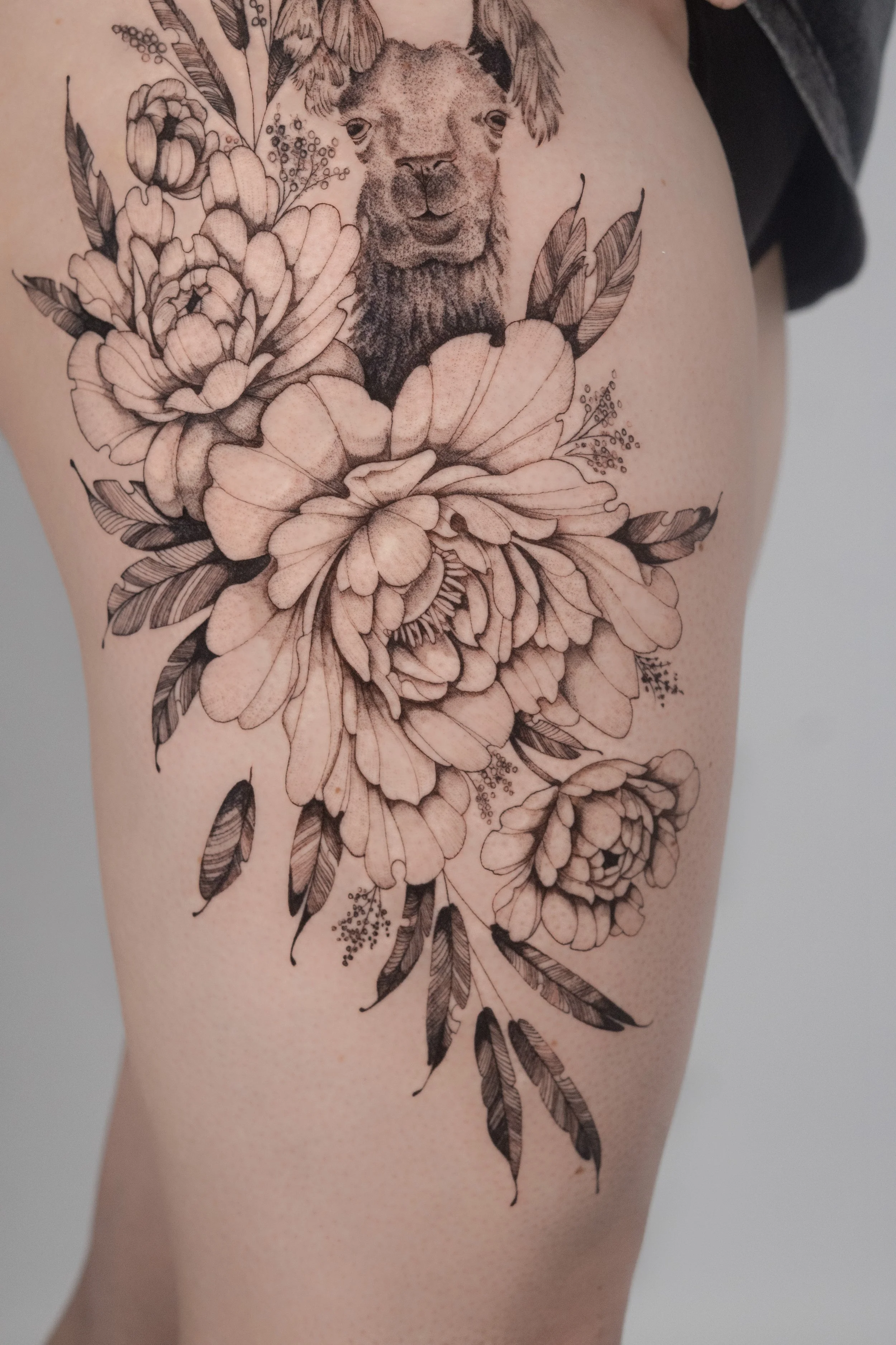 Peony hip tattoo by Anne Marriott at Skinzophrenic Tattoos Hereford