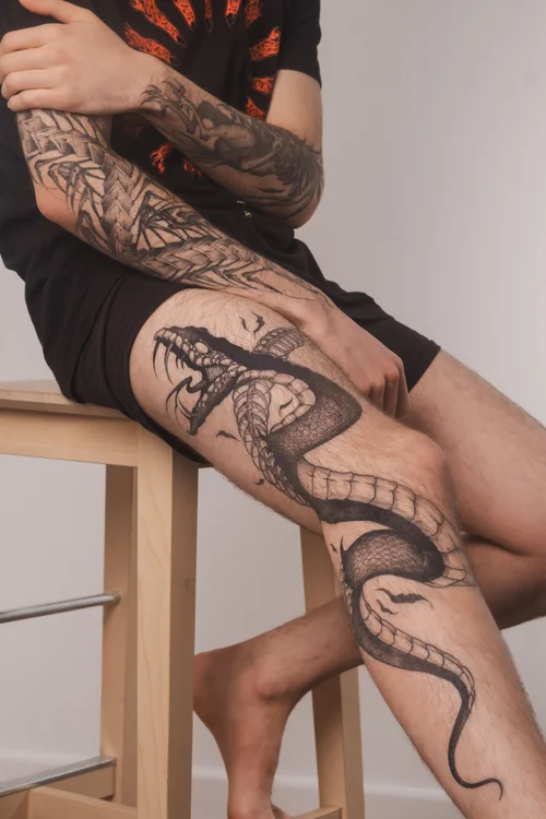 Snake leg tattoo by Mateusz Krygowski