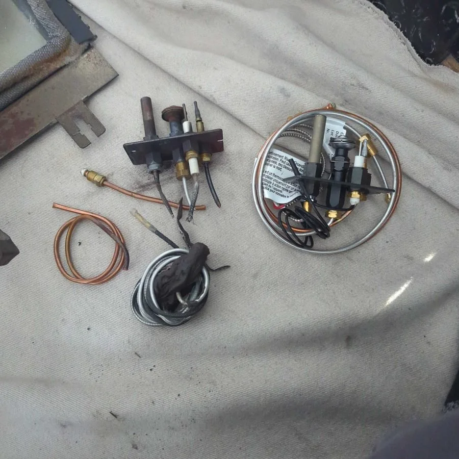 Replacement gas fireplace parts on a drop sheet