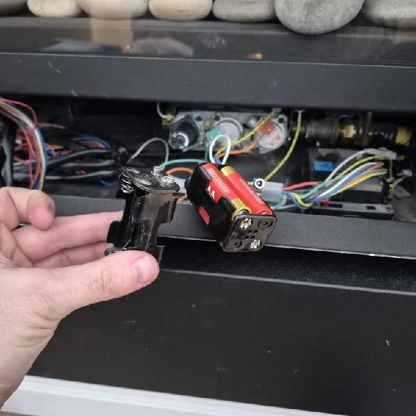 Gas fireplace battery pack being replaced