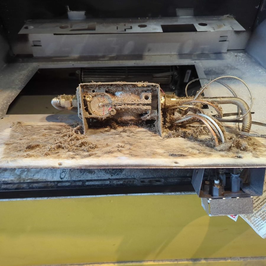 Dusty gas valve inside a fireplace