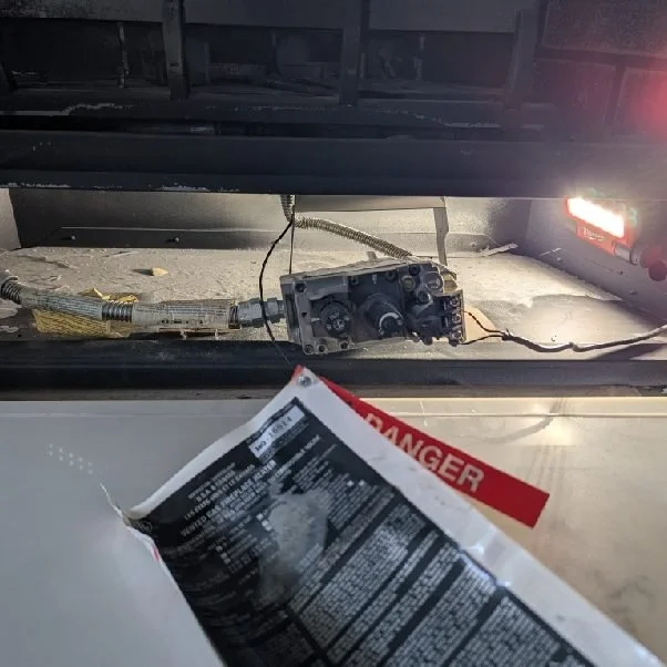 Gas fireplace valve being diagnosed under a work light