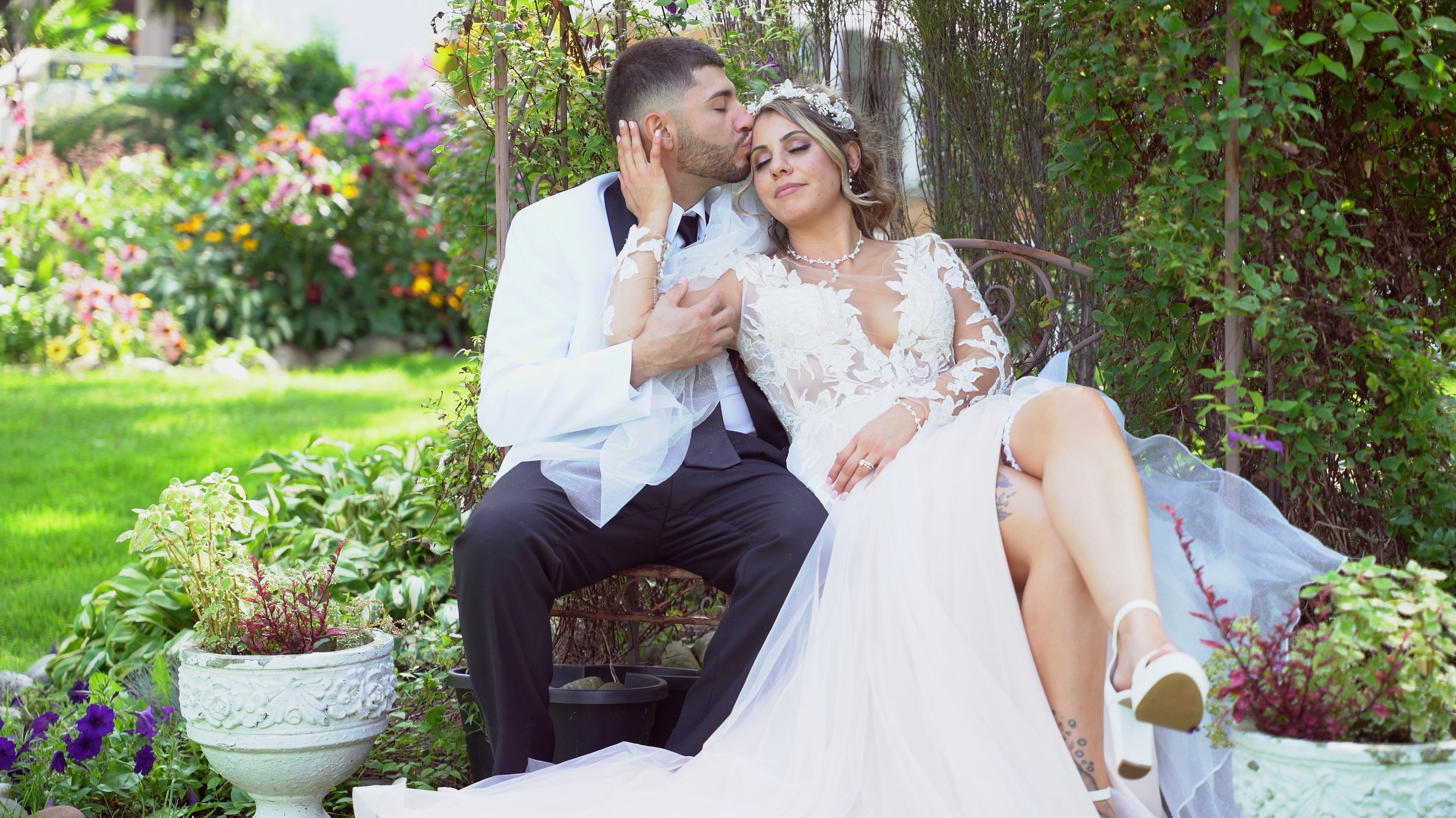Bride and groom seated in a garden