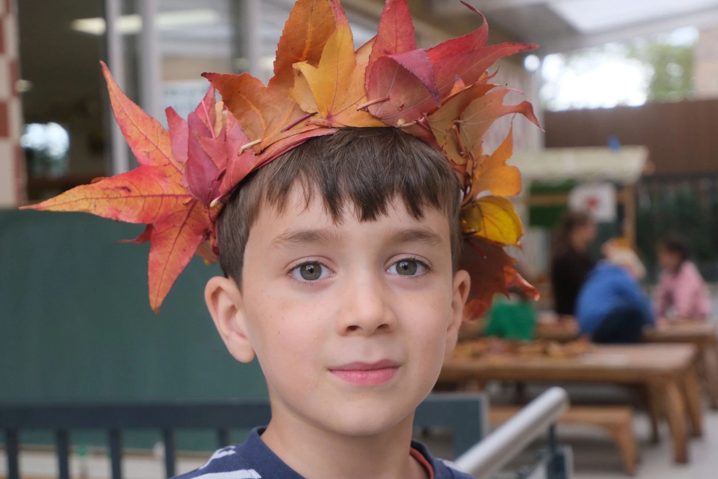 Child with leaf crown at camp