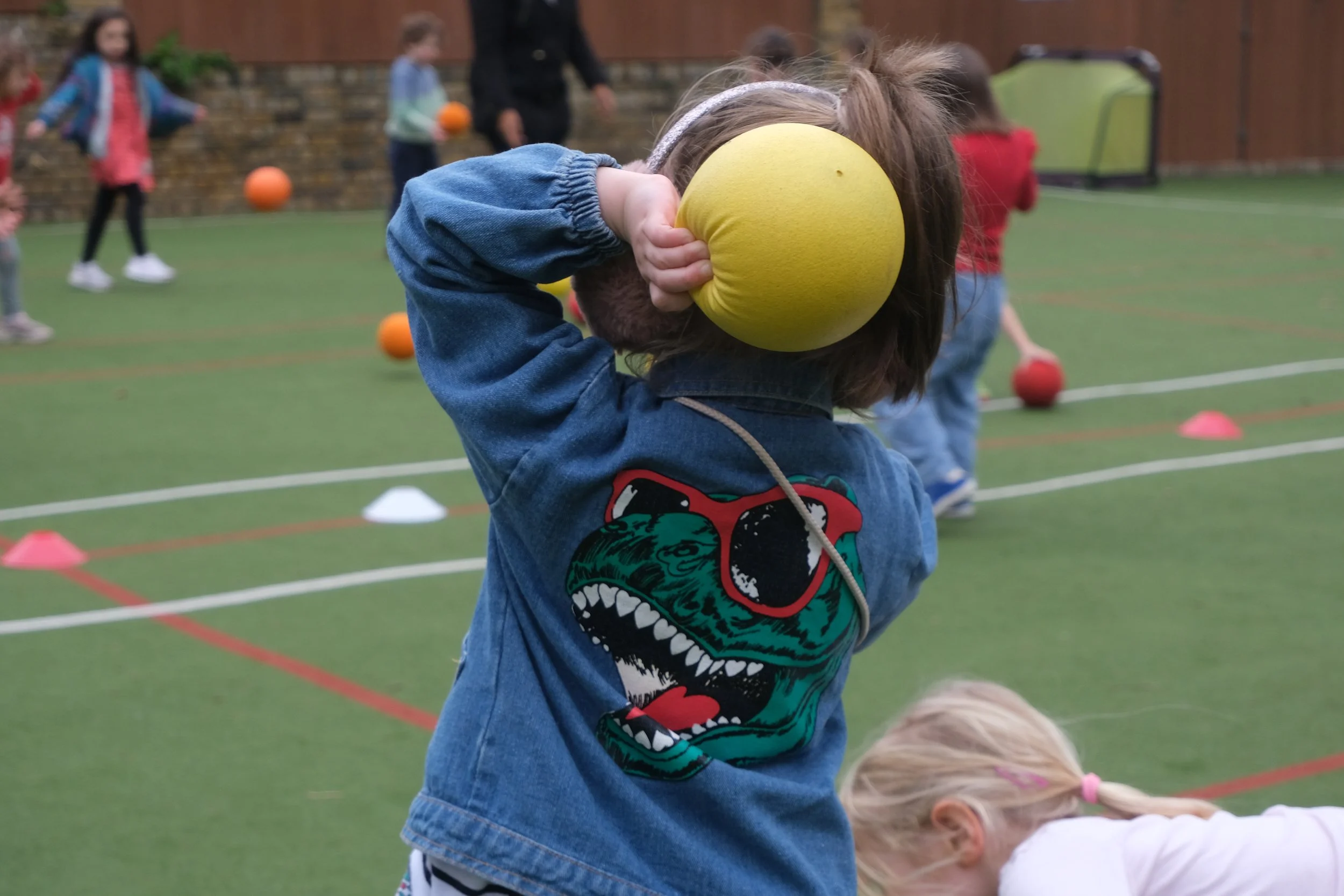 Girl throwing dodgeball at Evergreen camp