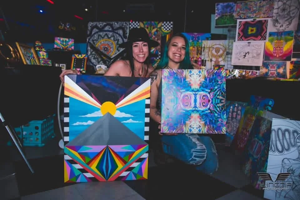 Two artists presenting their paintings together