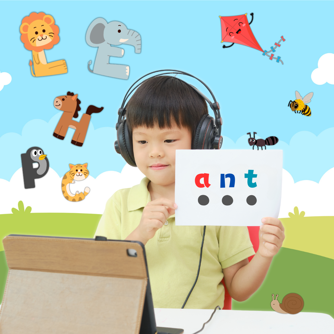 A young boy wearing headphones holding a phonics card reading ant