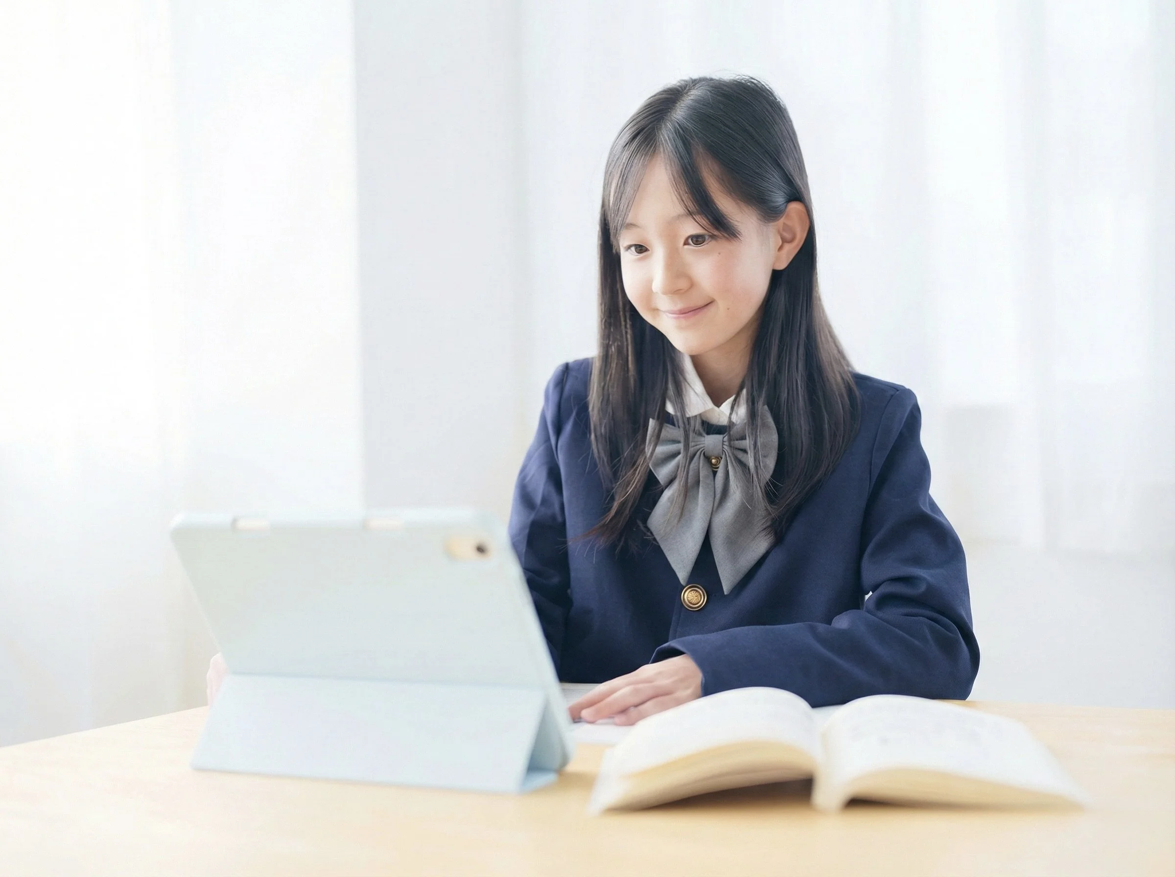 A student in school uniform studying with a tablet