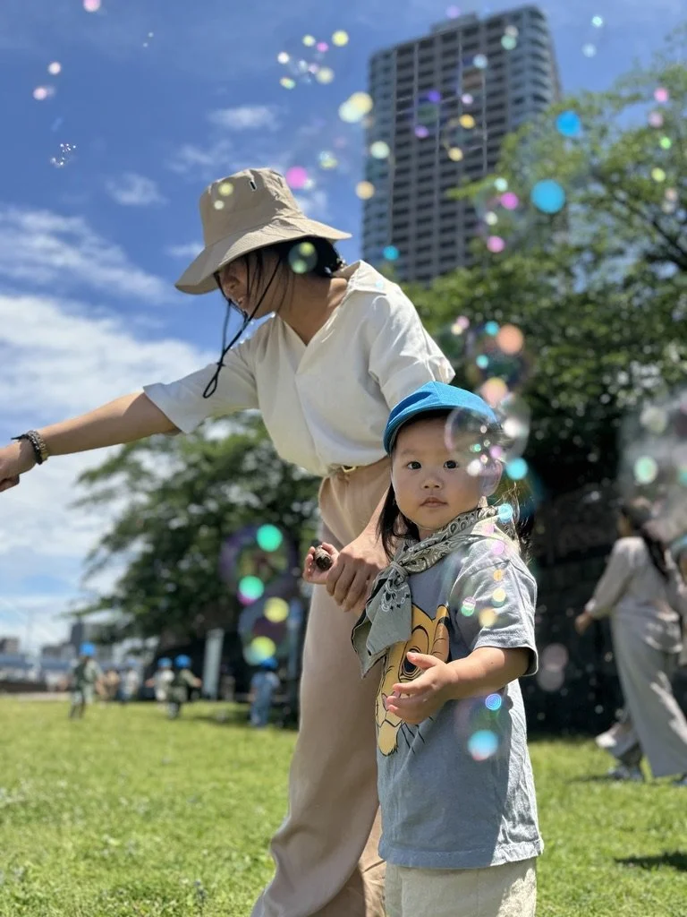 Parent and child playing joyfully among soap bubbles