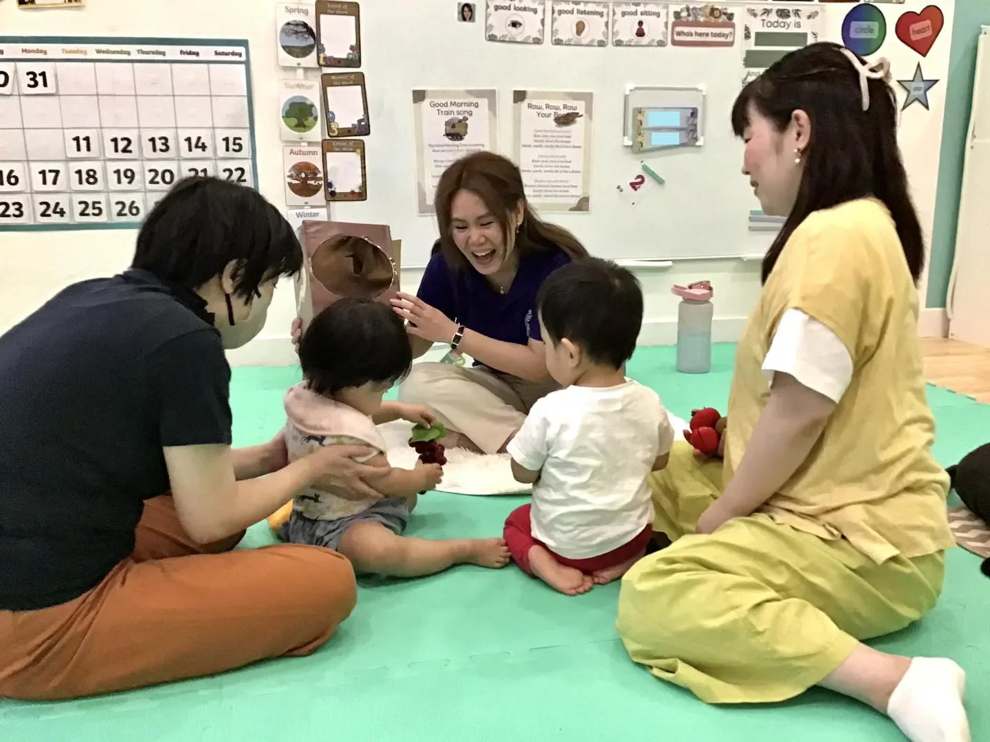 A parent and child laughing with the teacher