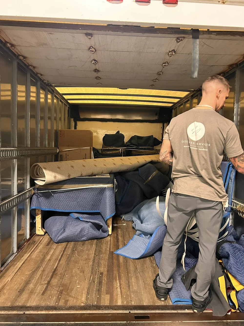 SL2 crew loading blanket-wrapped furniture onto the truck