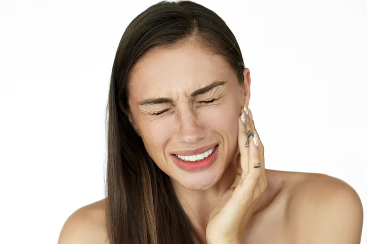 Woman touching the side of her jaw