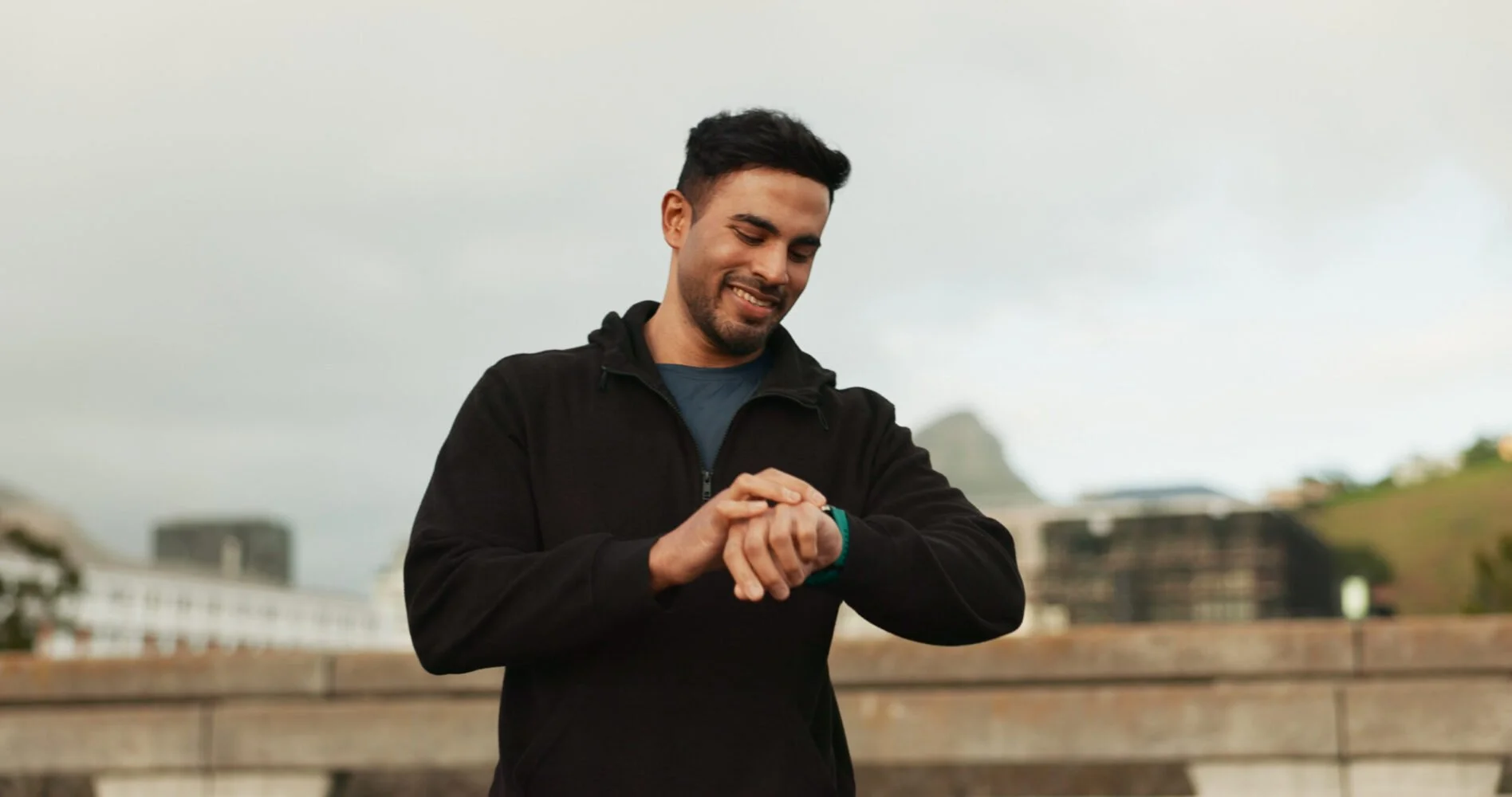 Man checking his watch outdoors