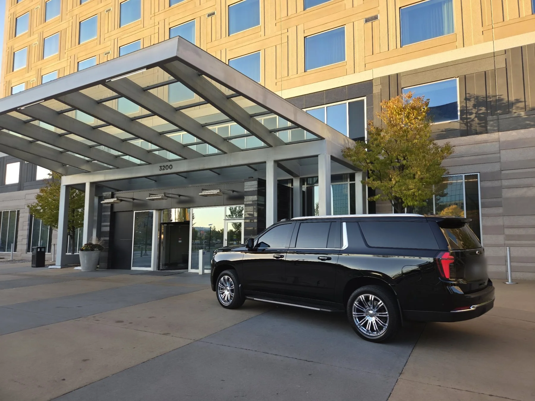 Chauffeured Suburban waiting at a corporate hotel entrance