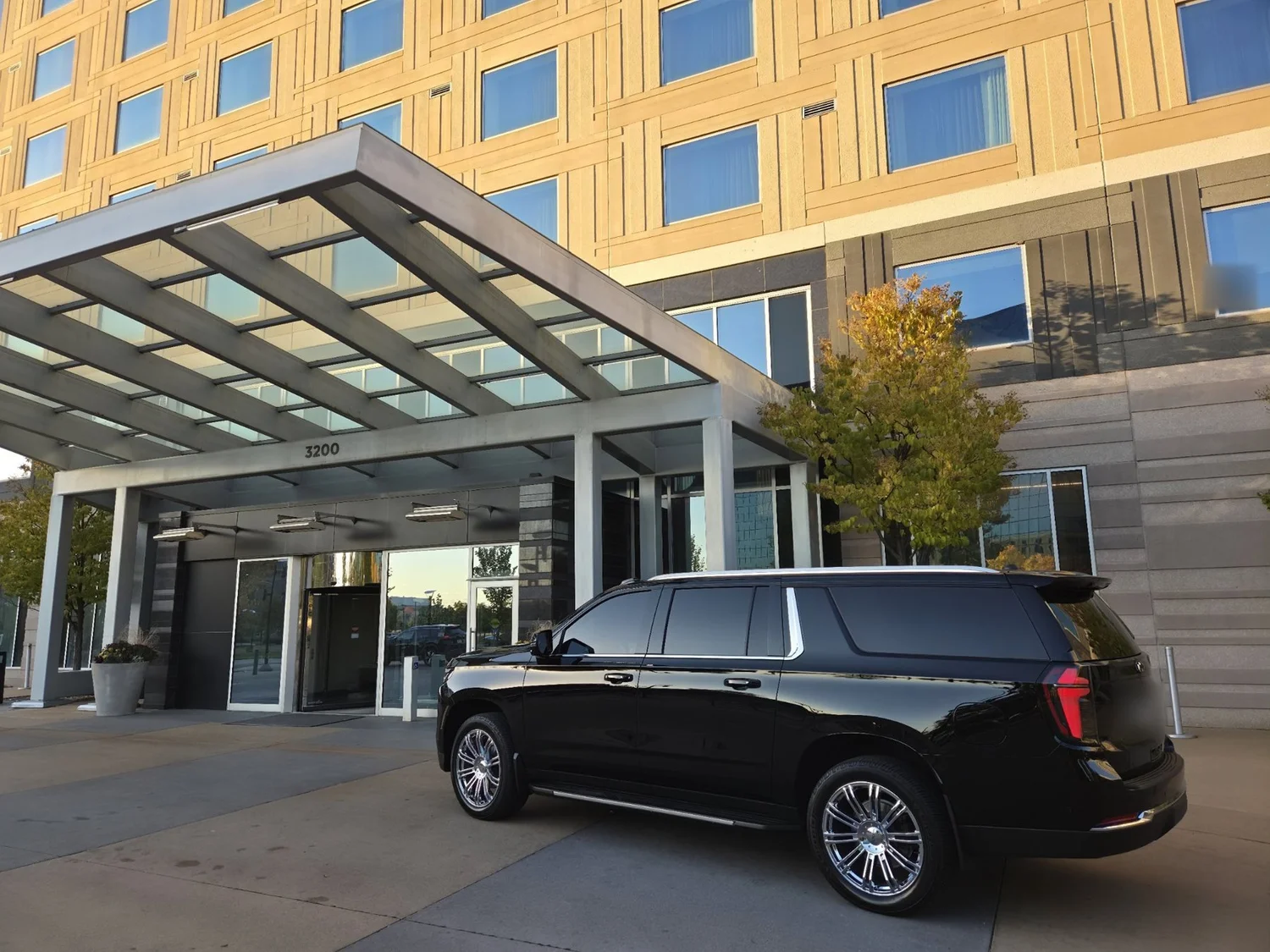 Chauffeured Suburban waiting at a corporate hotel entrance