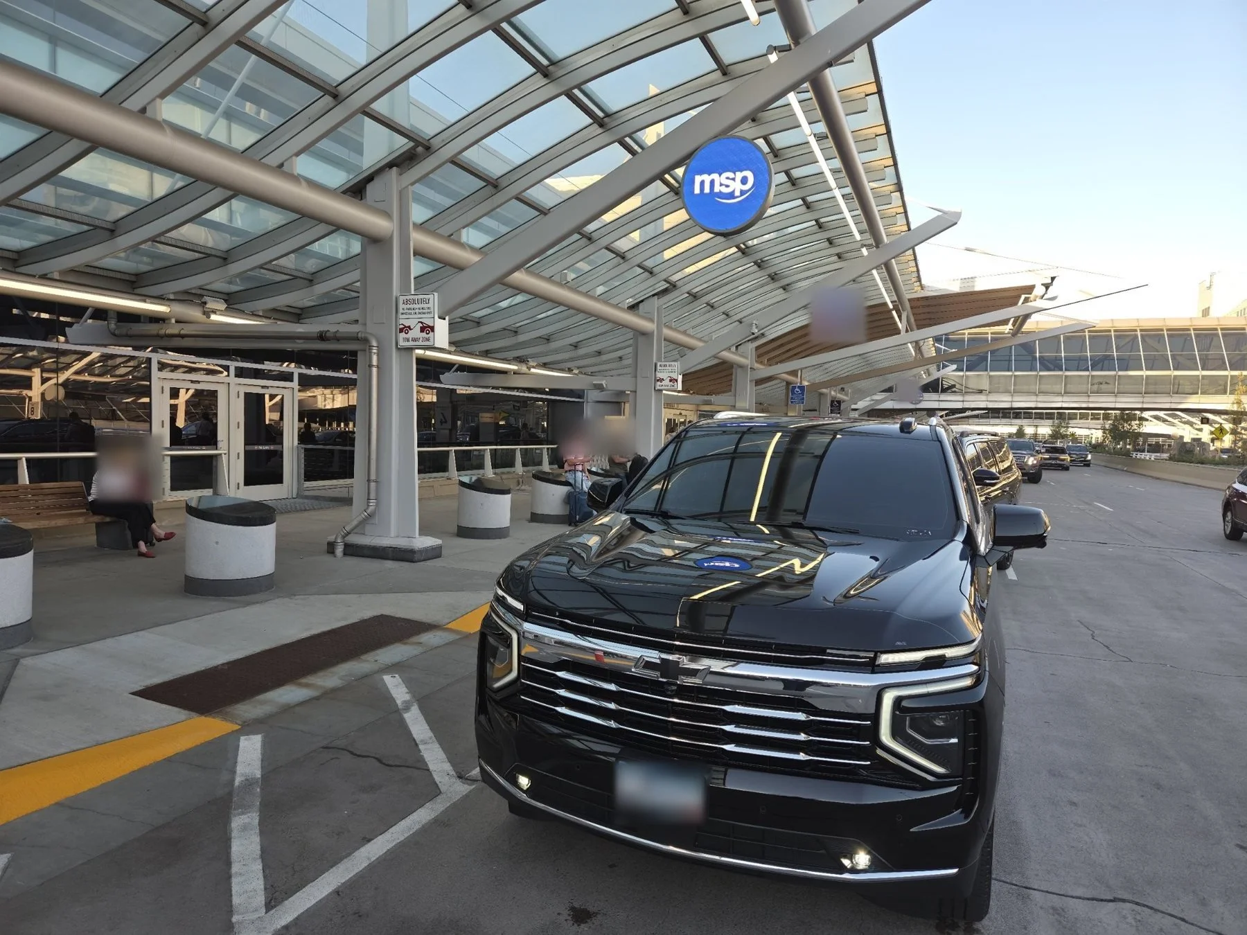 Chauffeured Suburban at the MSP Terminal 1 curb