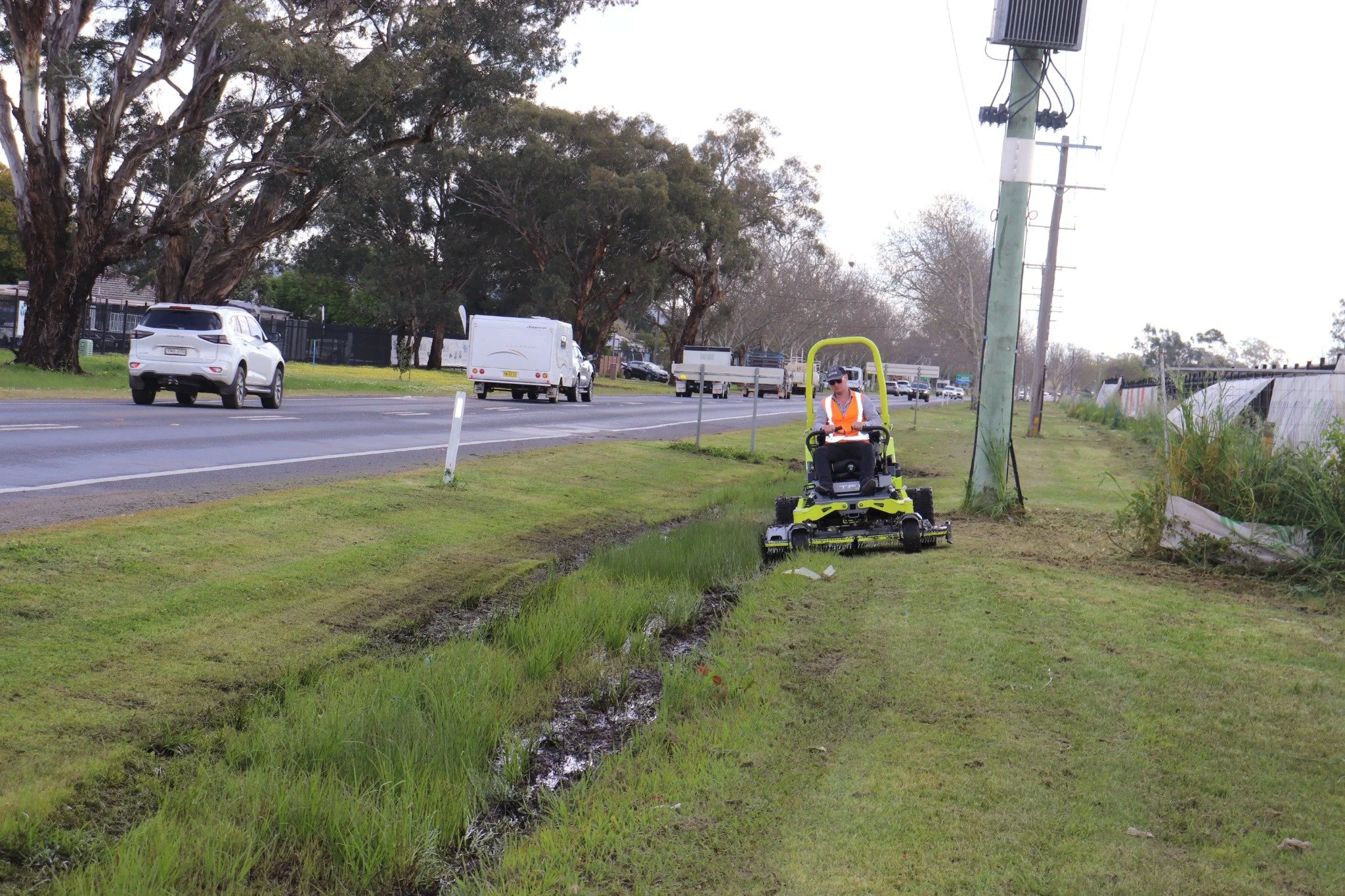 Altoz TFX maintaining grass along a roadside drainage channel