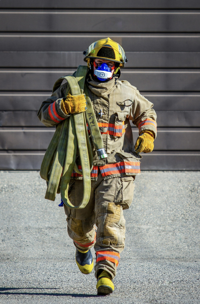 Firefighter carrying gear