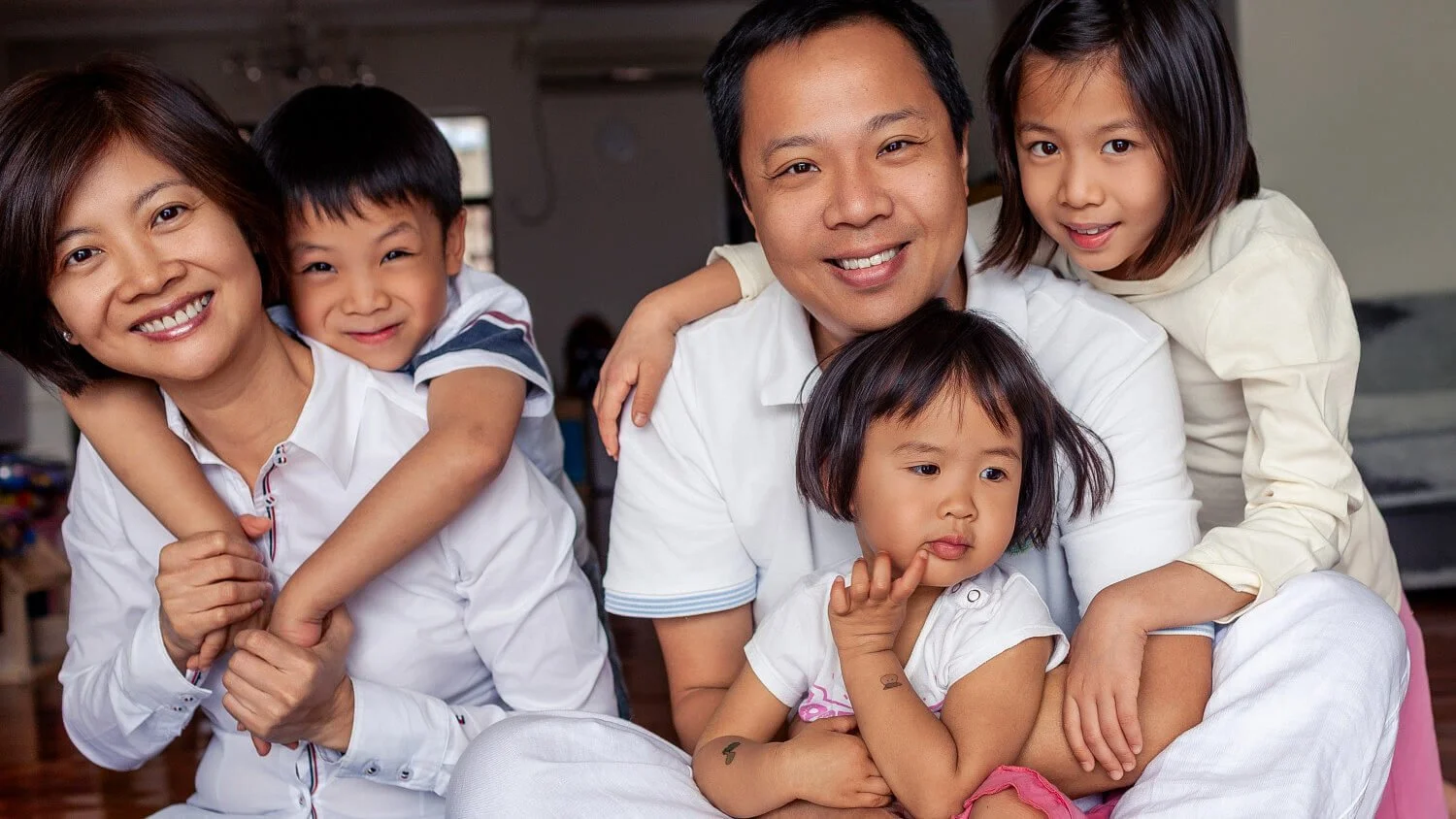 Window light studio portrait of complete family in Hong Kong.