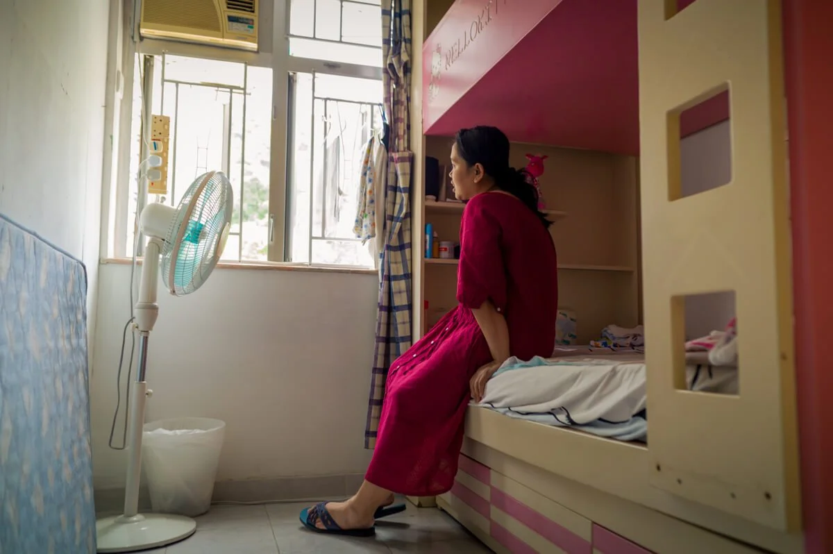Migrant woman in her apartment, for Pathfinders Hong Kong.