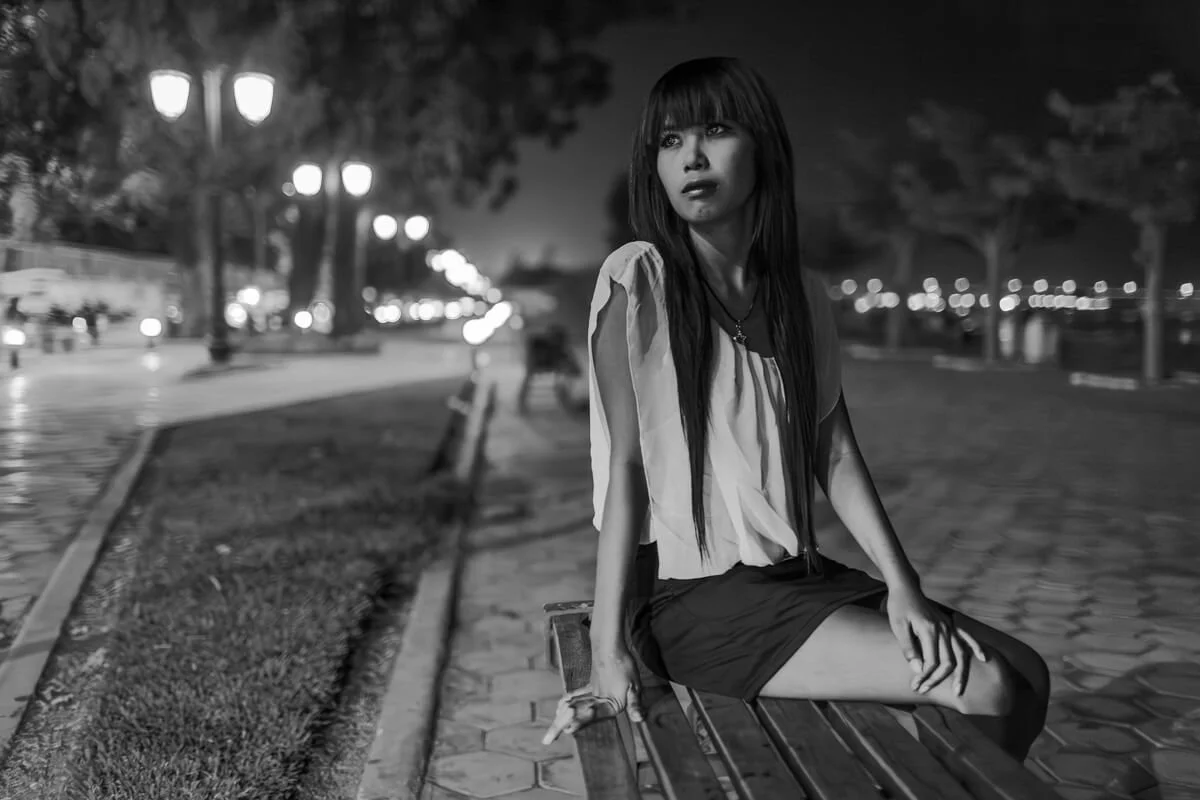 Young sex worker waits for customers on the Phnom Penh riverside.
