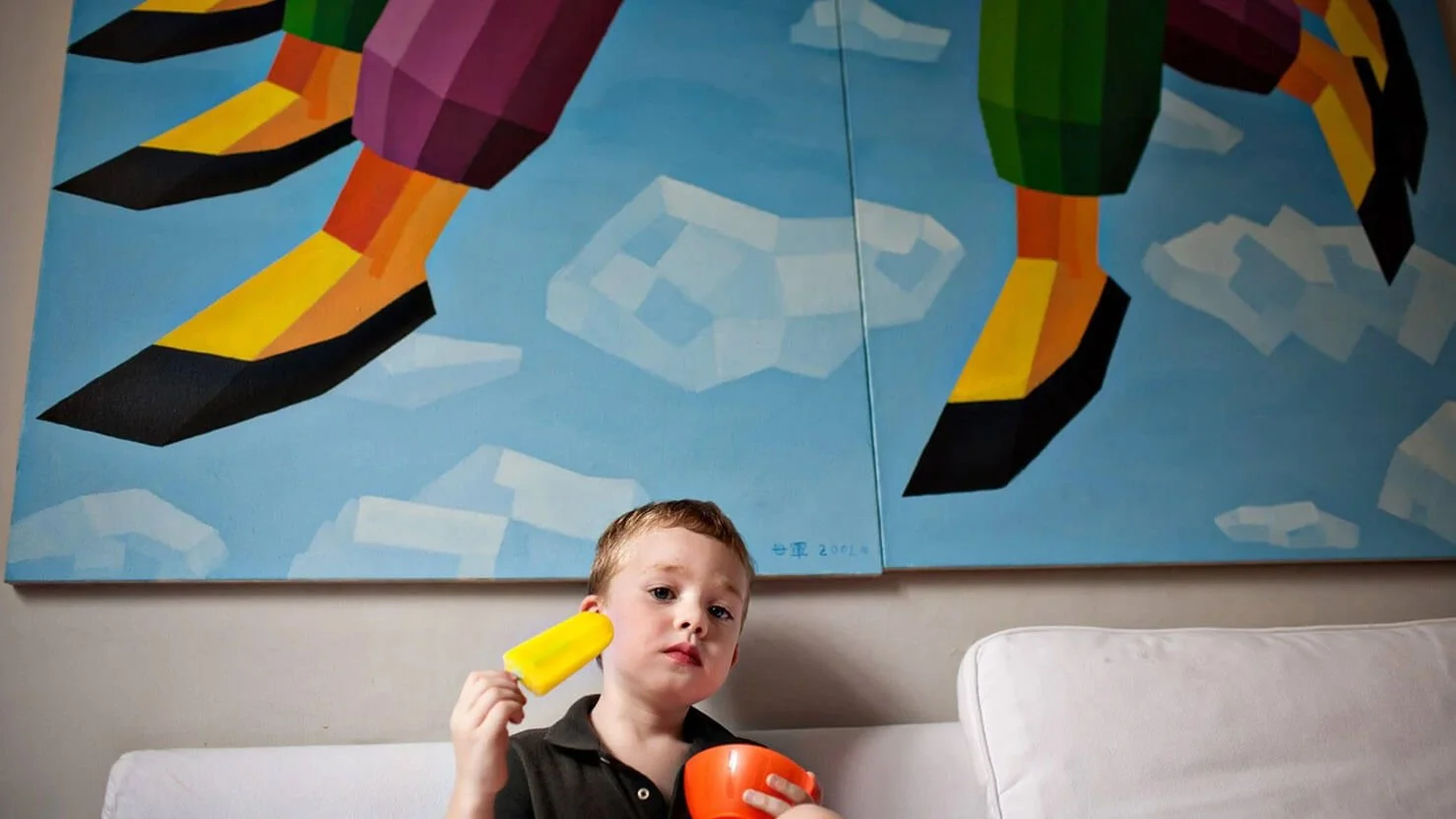 Boy eats yellow popsicle at The Peak, HK