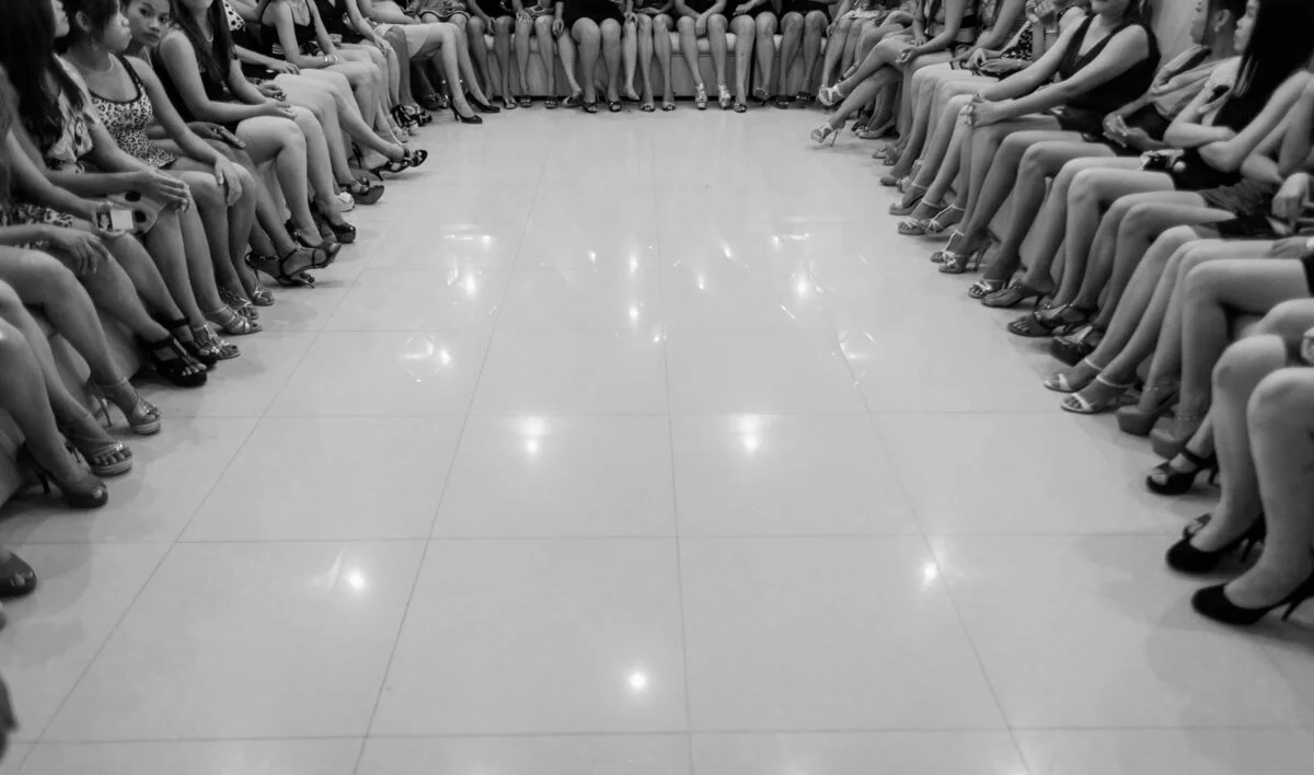 Woman wait for local customers at a massage parlour in Siem Reap, Cambodia.