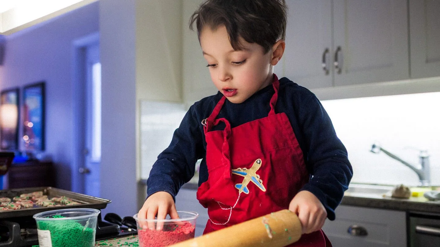 Young boy baking cookies.