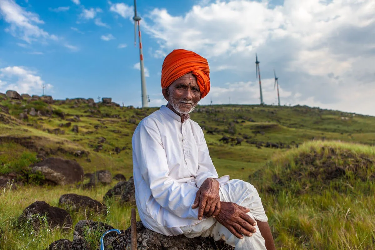 Farmer living in the shadow of Tata Wind Farm 50 MW in Maharastra, India