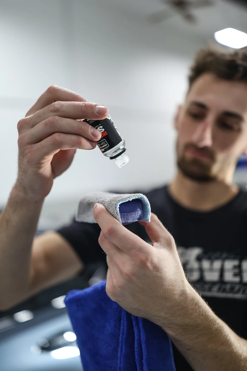 Ceramic coating being applied by hand to an applicator pad