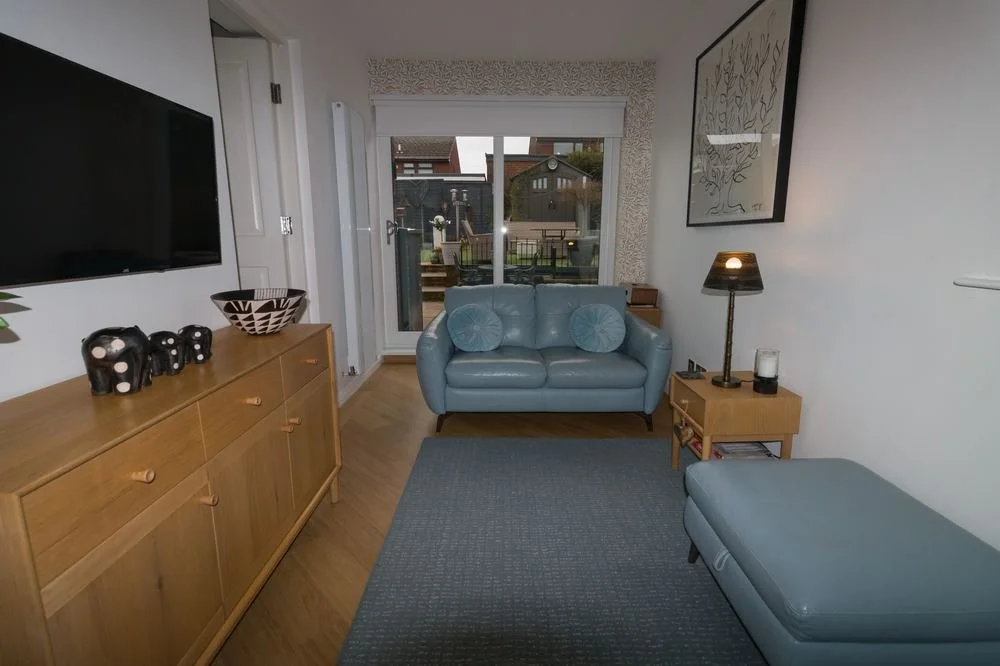Living room before TPPS training: workable but uneven light and a loose, distracting composition