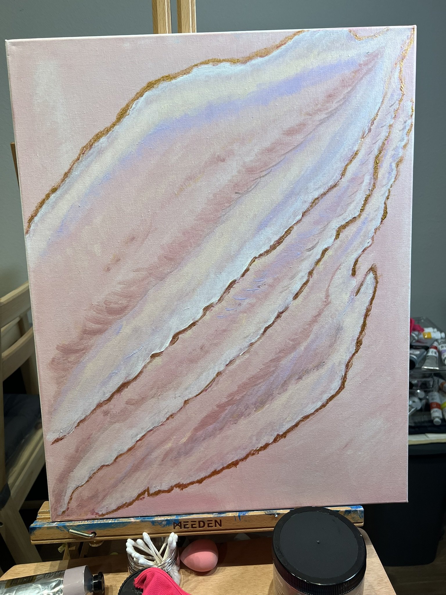 Stephanie’s original blush, ivory and gold painting on its easel.