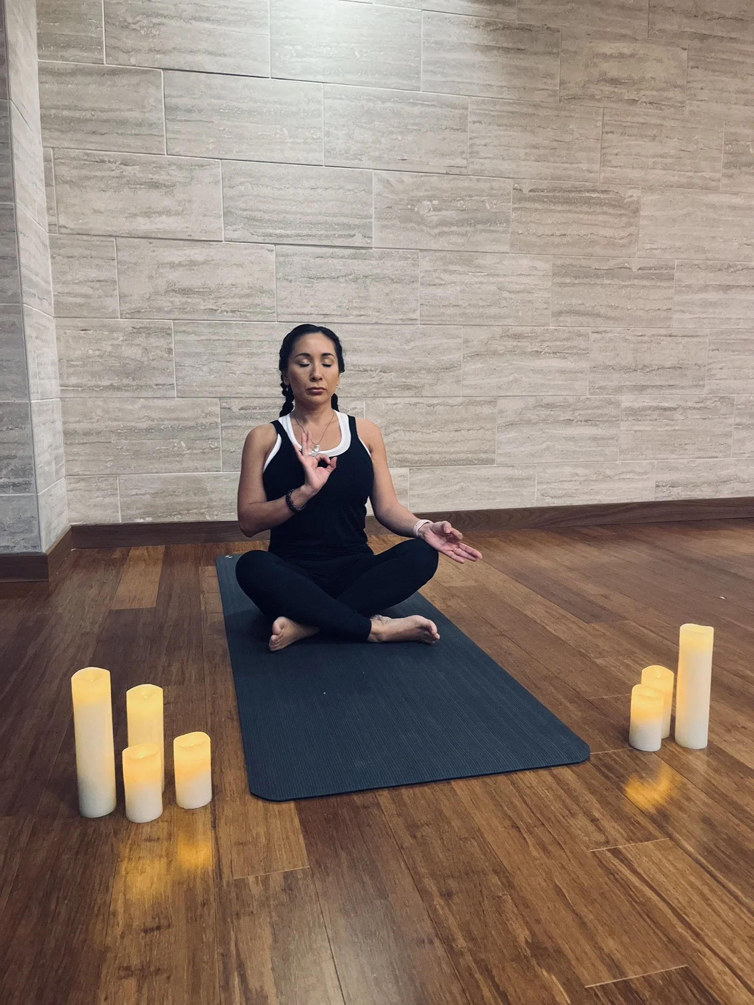 Stephanie meditating with candles
