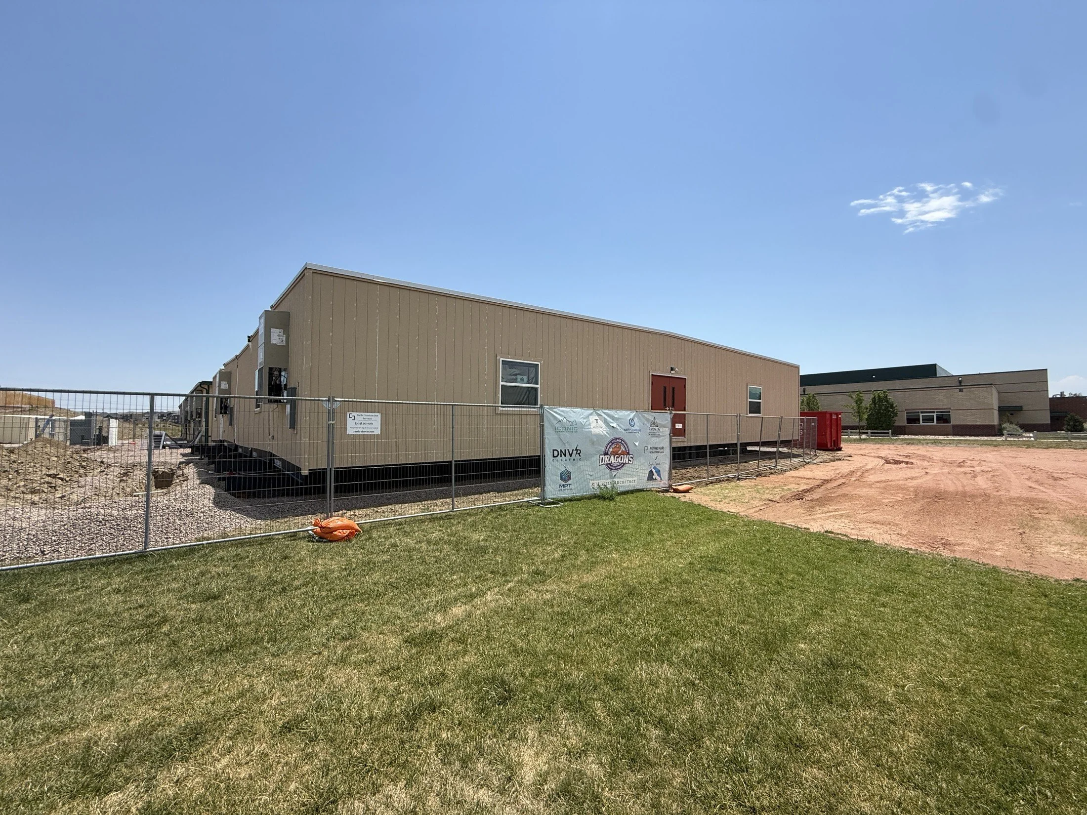 Sproul modular school building with DNVR Electric on the project-team banner