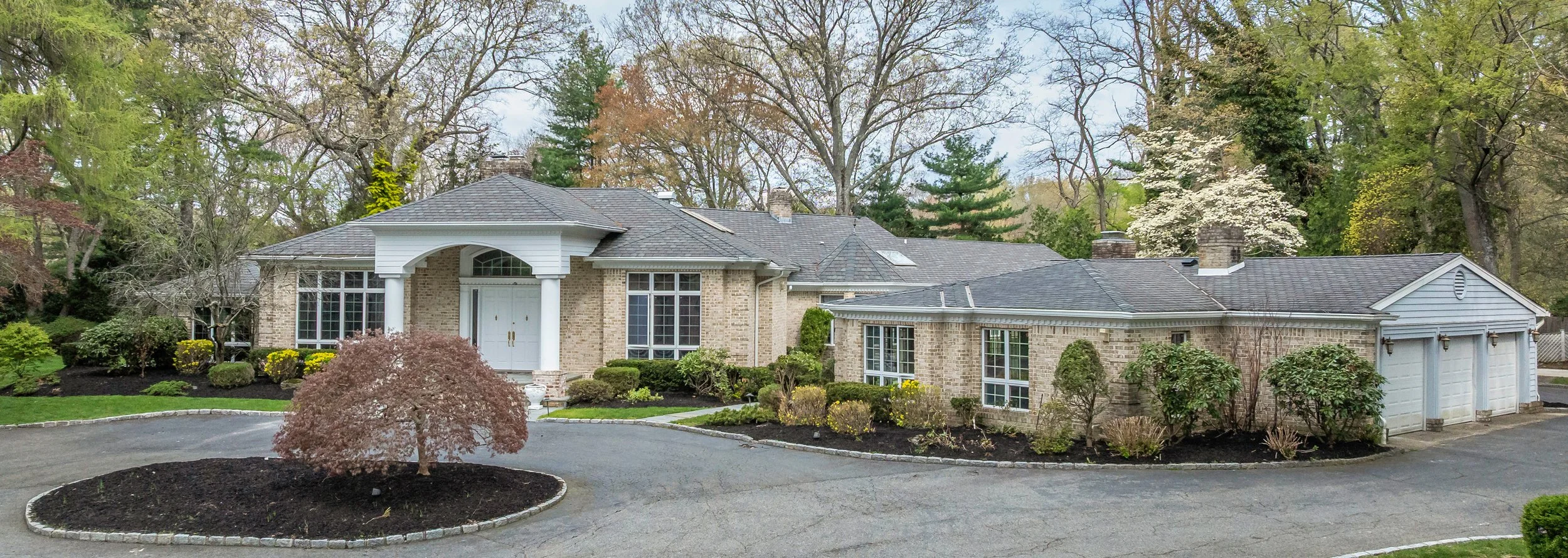 Long Island estate drone front facade circular driveway — Palma Design
