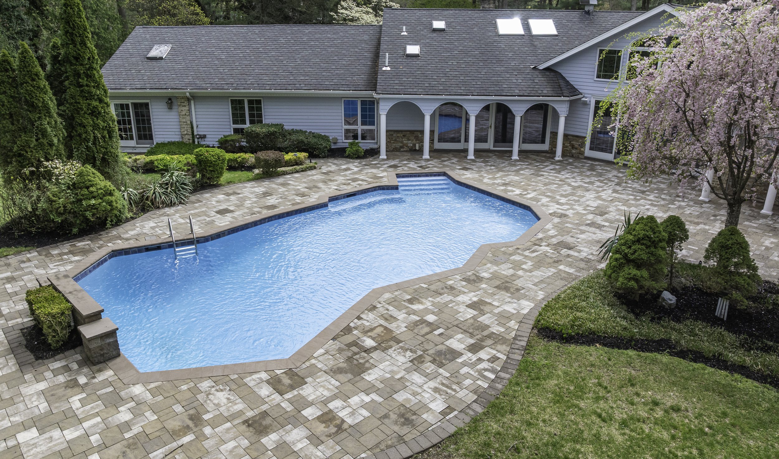 Long Island estate aerial pool colonnade — Palma Design