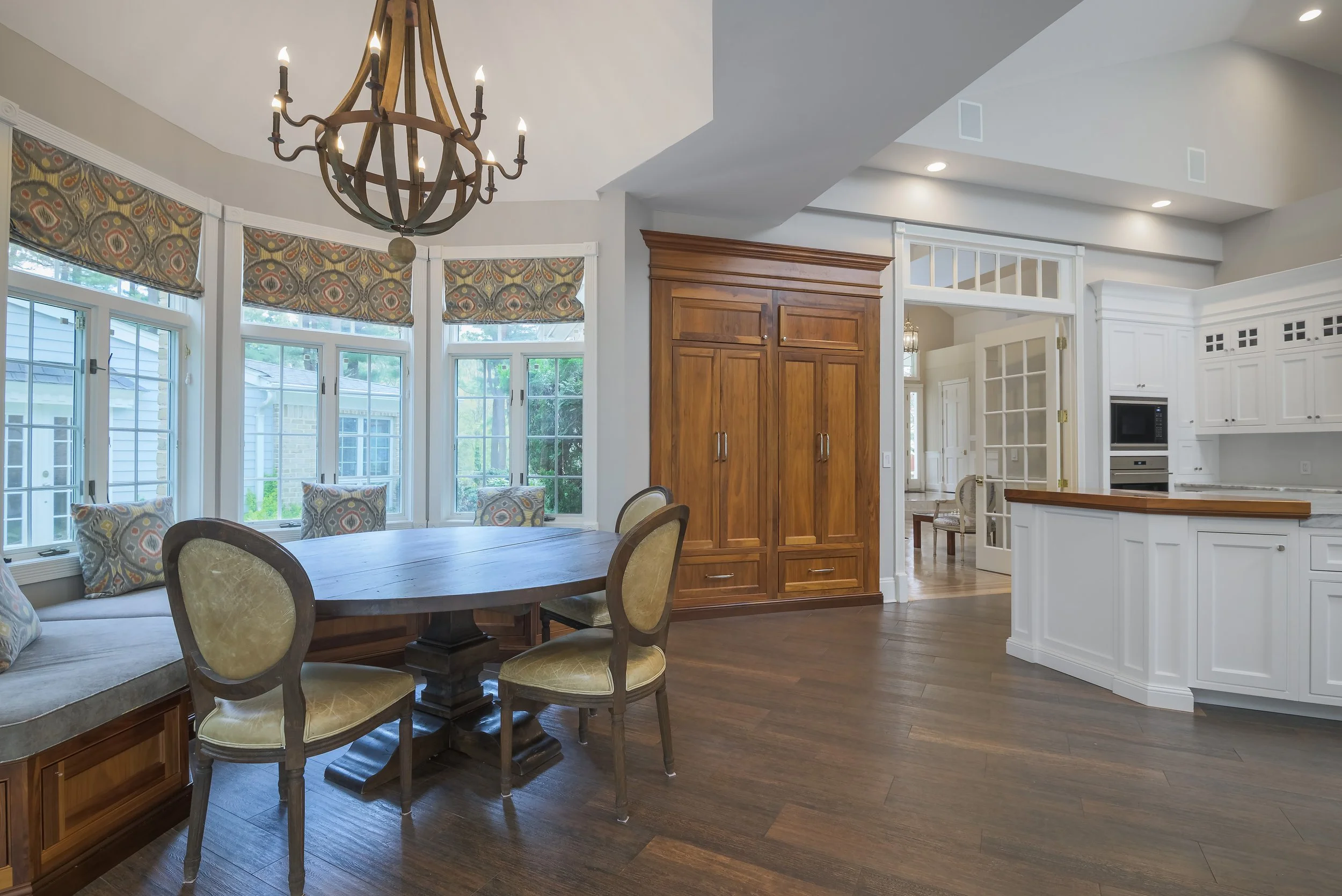 Long Island estate breakfast nook chandelier walnut panel — Palma Design