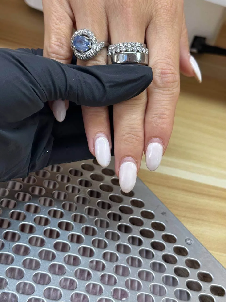 Client's nails with existing light-colored dip powder before removal and almond reshaping at Mars Nails