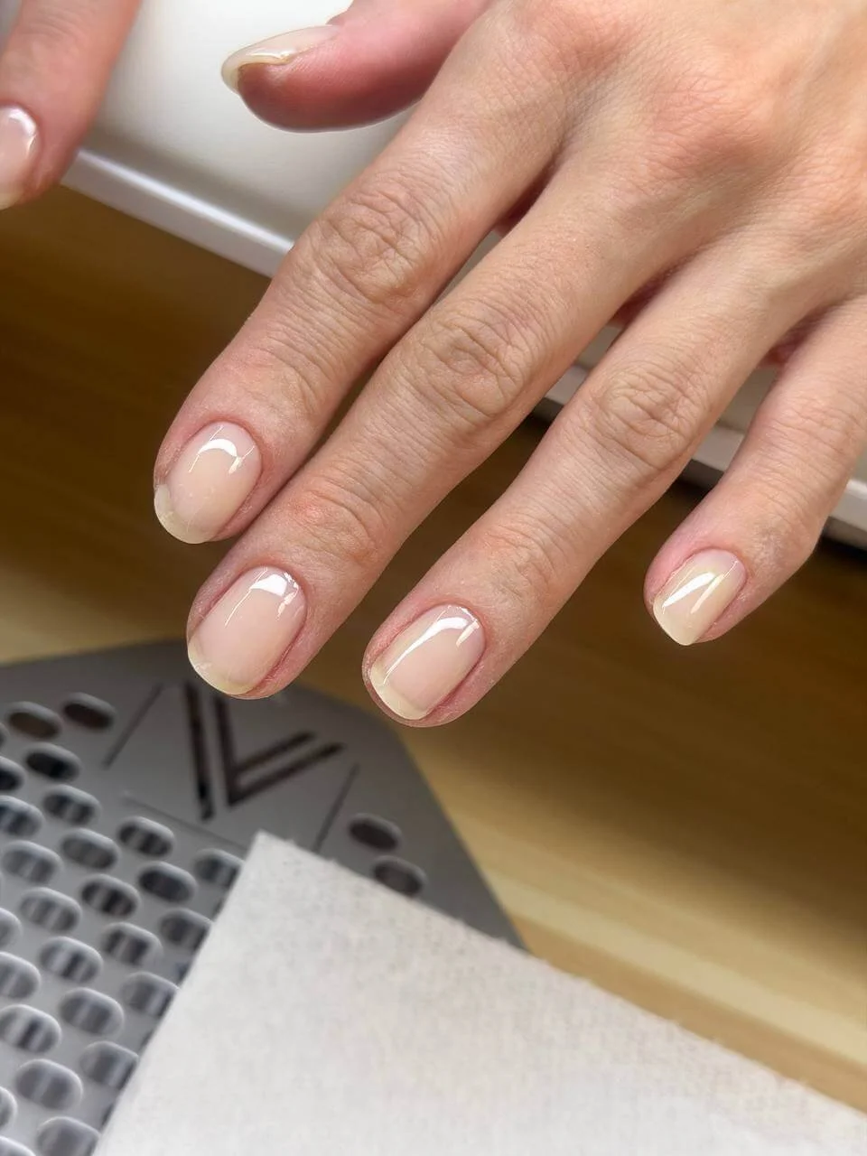Natural-looking nail tips after localized hard gel reinforcement and before red gel color