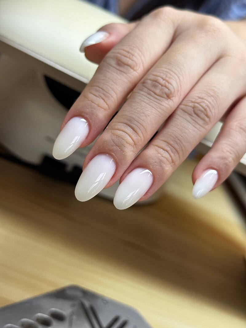 Milky almond wedding nails after sculpting