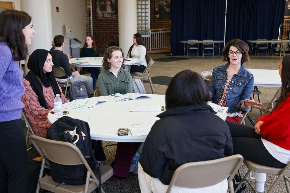 Students talk with a tnAchieves mentor around a table