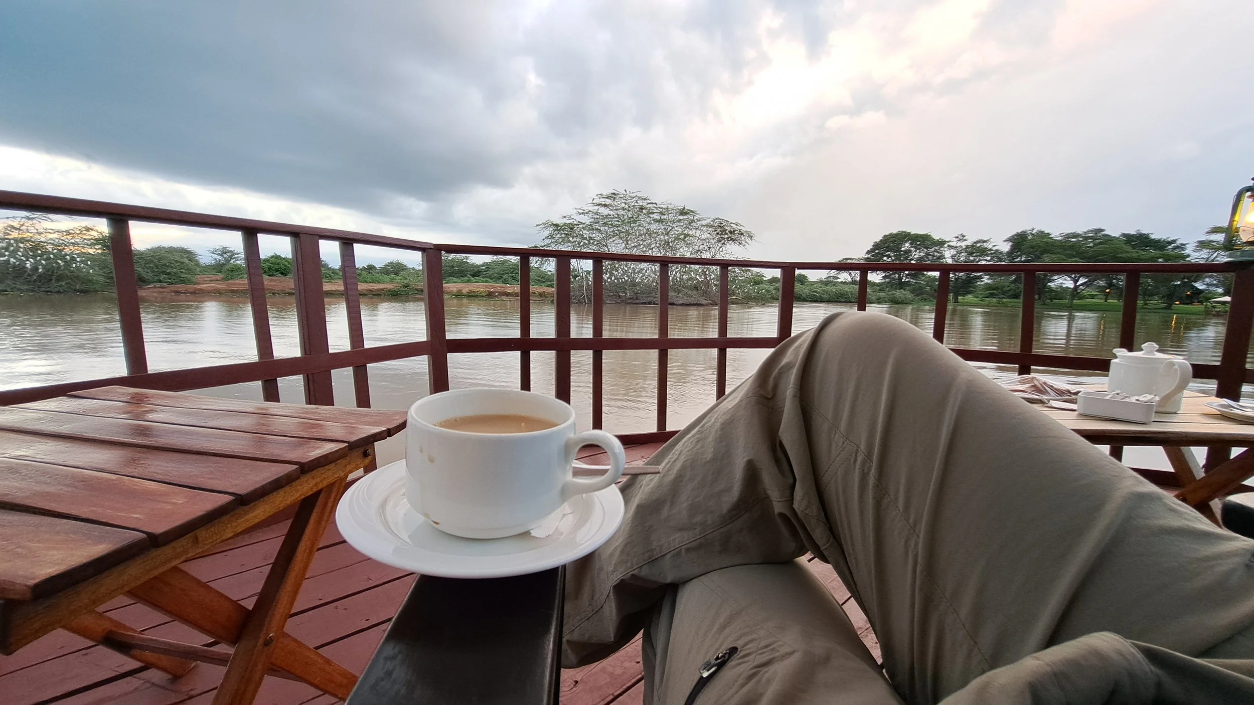 Calm travel pause on a lodge deck overlooking water