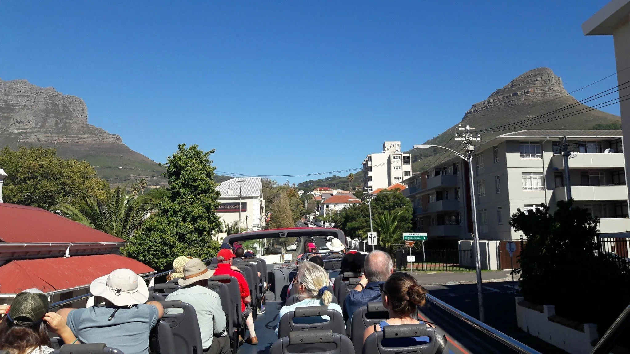 Middle-aged tourists enjoying a city-seeing bus ride in Cape Town, South Africa.