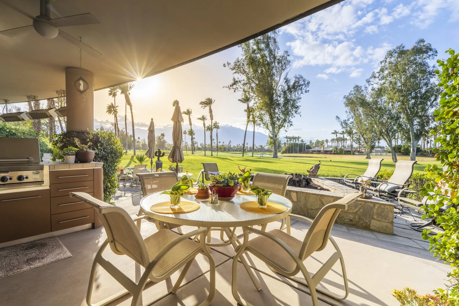 Covered patio with a dining table looking out over a golf course