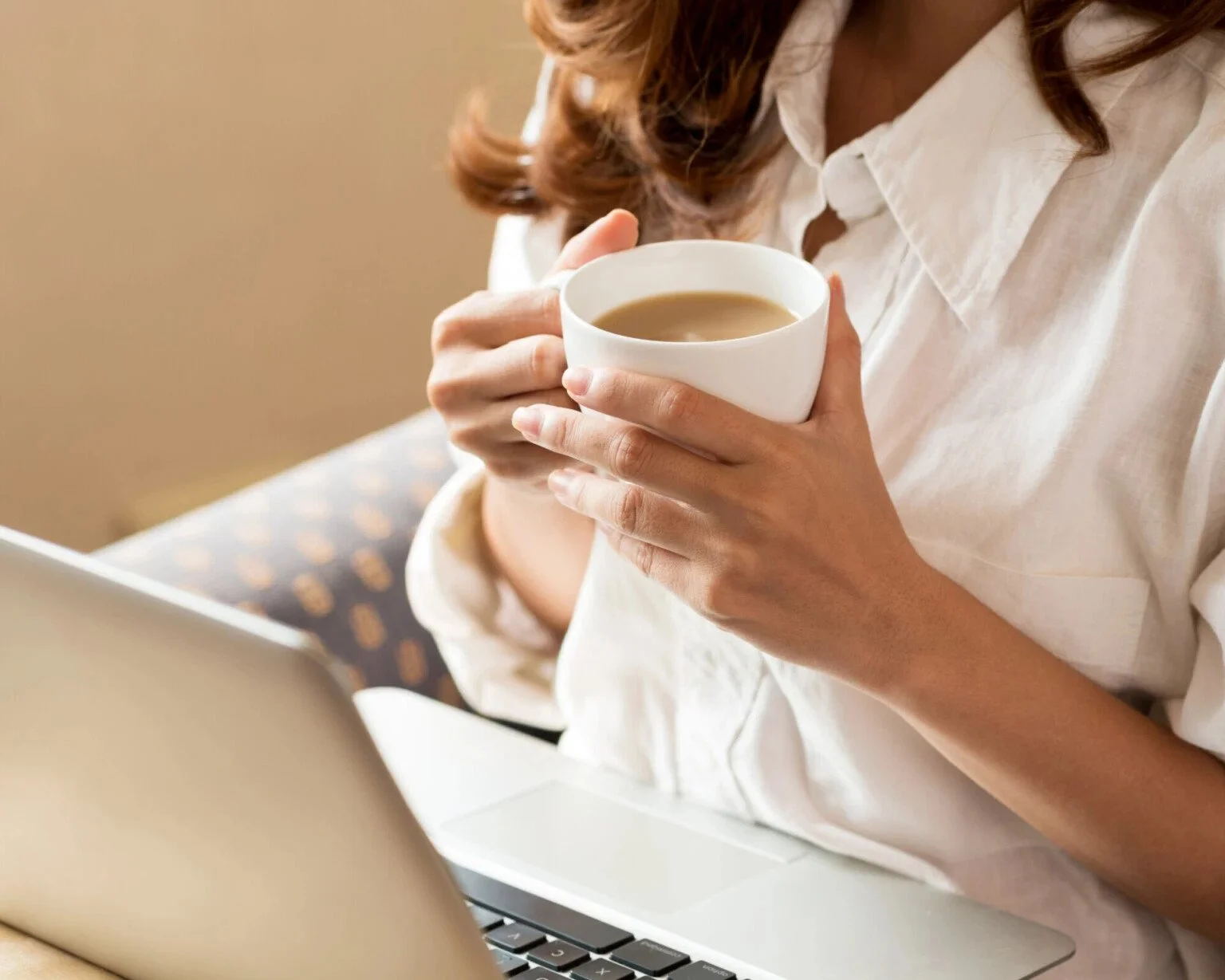 Woman with coffee and laptop