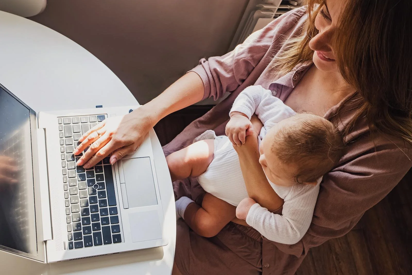 Mother working remotely with baby